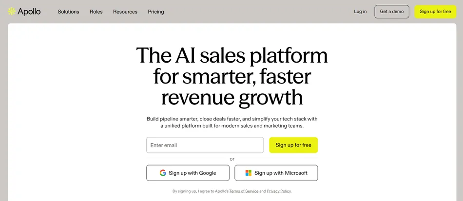 A screenshot of the Apollo AI sales platform homepage, featuring a large headline 'The AI sales platform for smarter, faster revenue growth' and a form to enter an email and sign up for free, along with options to sign up with Google or Microsoft. The navigation bar at the top includes links for Solutions, Roles, Resources, Pricing, Log in, Get a demo, and Sign up for free.