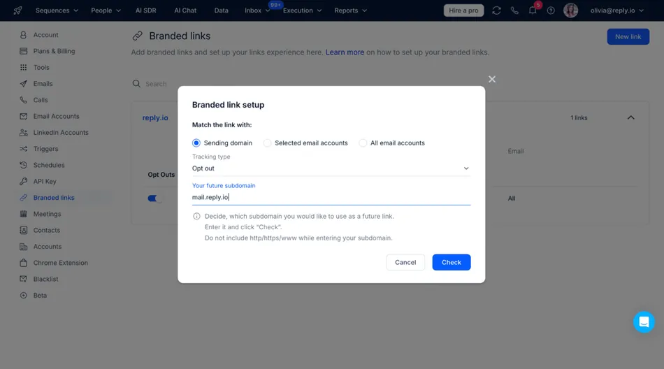 A screenshot of the Reply.io application showing a 'Branded link setup' modal. The modal allows the user to match the link with 'Sending domain', 'Selected email accounts', or 'All email accounts', choose a 'Tracking type' of 'Opt out', and enter 'Your future subdomain', which is currently mail.reply.io.